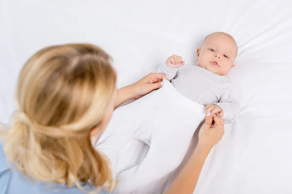 Mother dressing baby — Stock Photo, Image