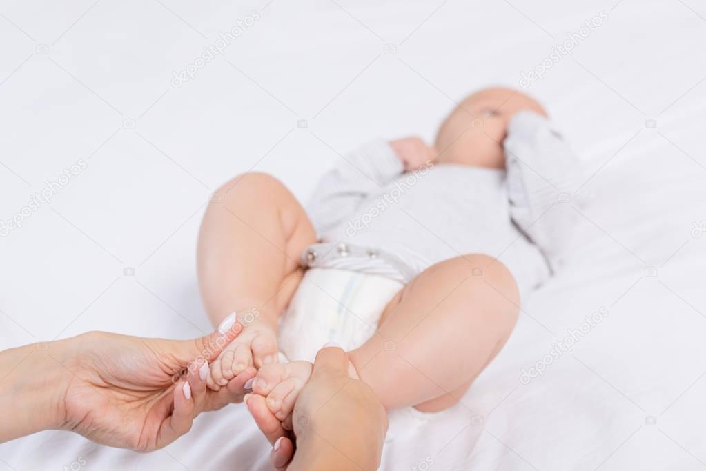 mother holding babys feet