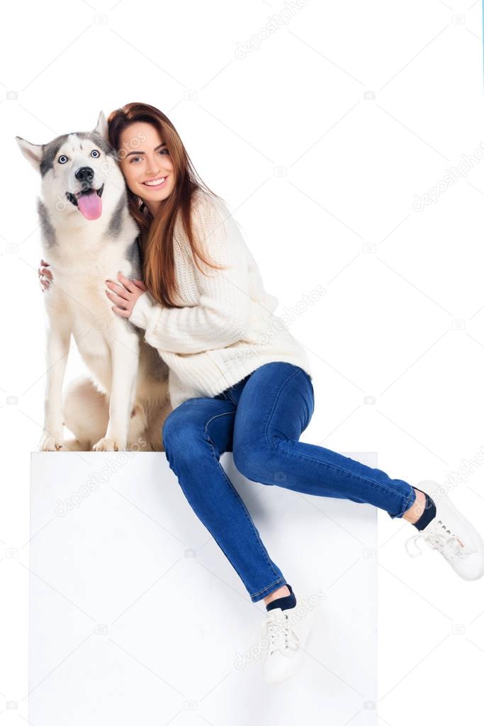 beautiful cheerful girl hugging husky dog, isolated on white