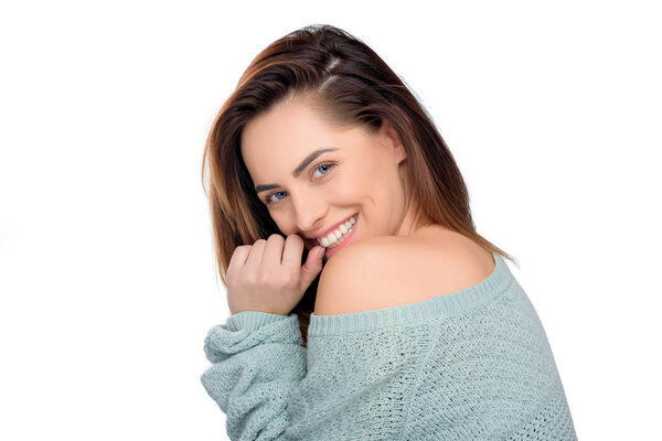 beautiful cheerful woman in sweater looking at camera, isolated on white