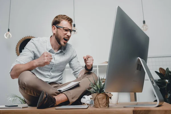 Businessman sitting on table — Stock Photo