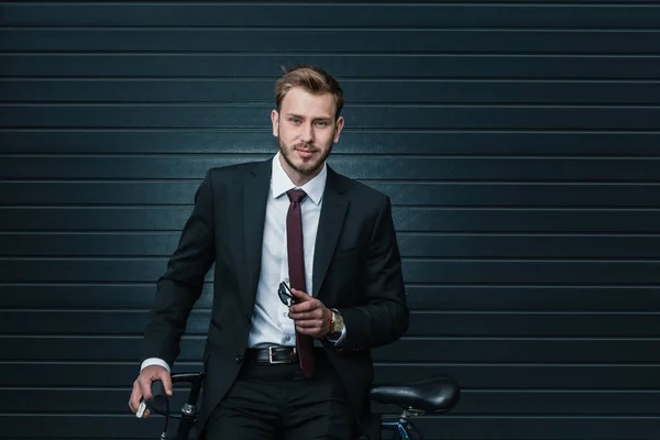 Stylish businessman with bicycle — Stock Photo