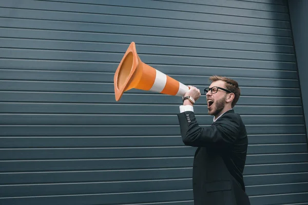 Businessman with traffic cone — Stock Photo