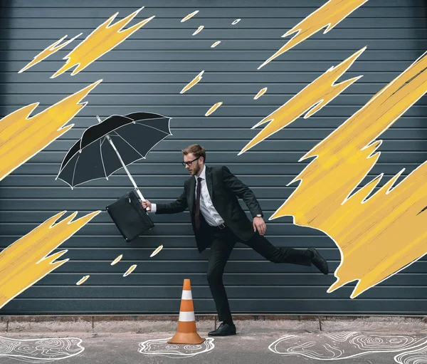Businessman running with umbrella — Stock Photo