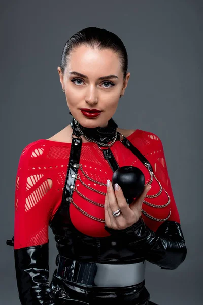 Attractive hot girl holding black apple isolated on grey — Stock Photo