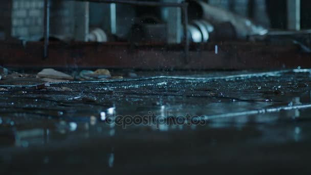 Raindrops falling into the ground from the ceiling. Old fabric building. Macro shot, close up, Slow Motion — Stock Video