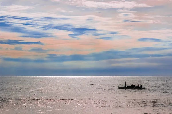 fishermen sets sail to sea at dusk