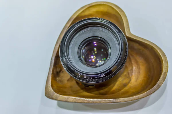 50mm lens on a heart shaped wooden bowl — Stock Photo, Image