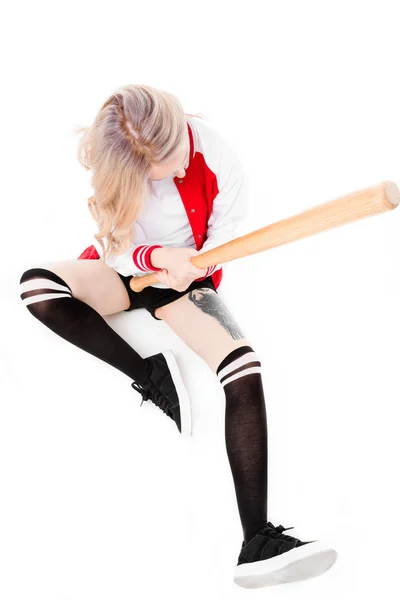 Woman sitting and holding baseball bat — Free Stock Photo