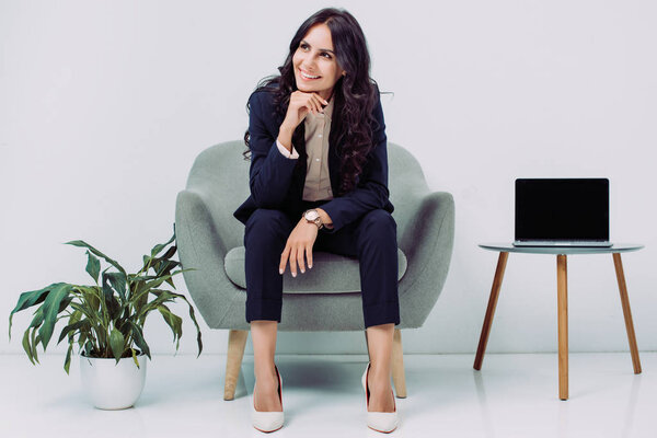 businesswoman sitting in armchair