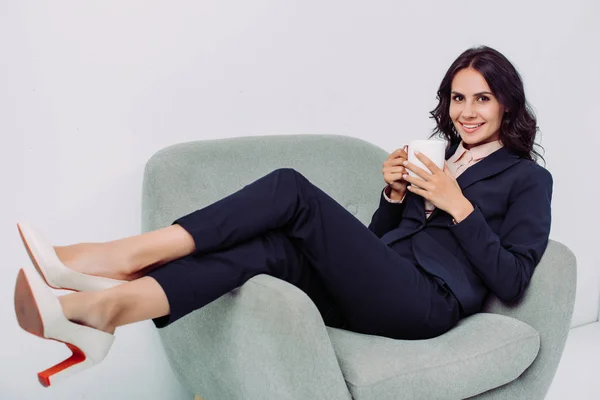 Businesswoman with cup of hot drink — Stock Photo, Image