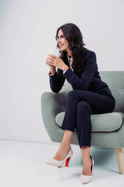 Businesswoman with cup of hot drink — Stock Photo, Image