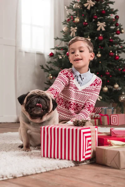 Boy with cute pug on christmas — Stock Photo, Image