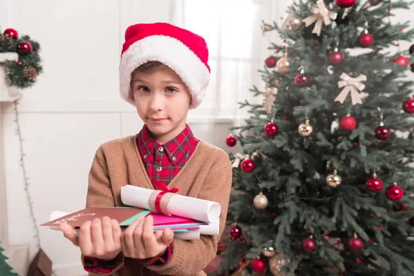 Boy with letters for santa — Free Stock Photo