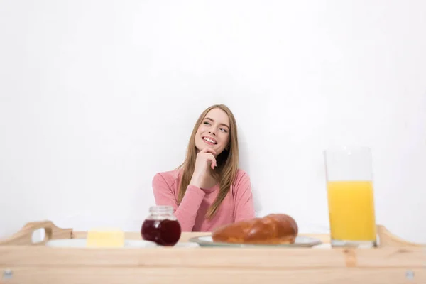 Woman with breakfast on wooden tray — Free Stock Photo