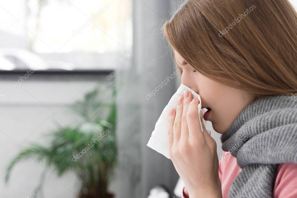 Sick girl wiping nose