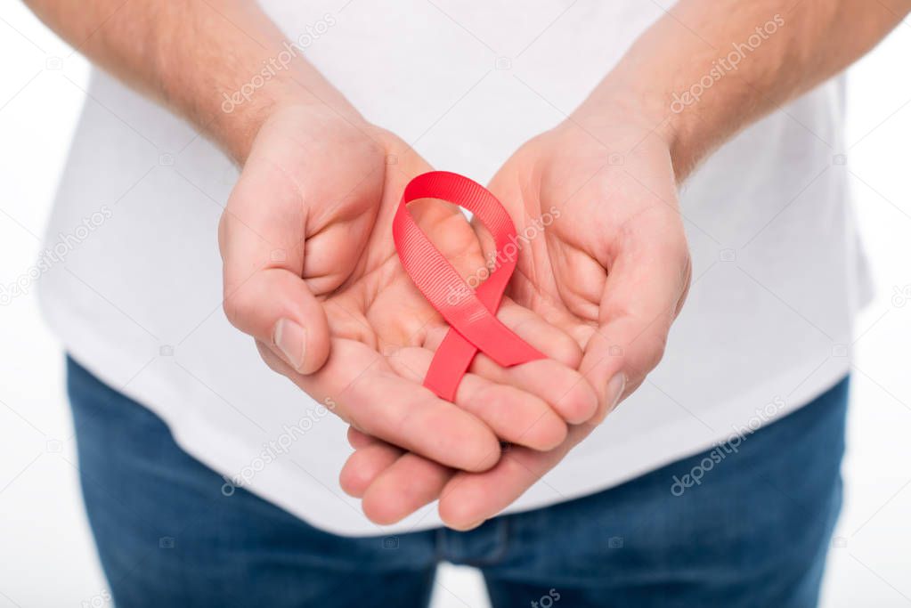 man holding aids ribbon