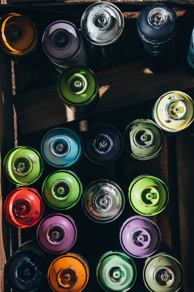 top view of cans with colorful aerosol paint 