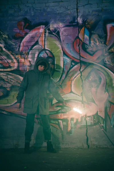 Man Holding Smoke Bomb Standing Wall Graffiti Night — Stock Photo, Image