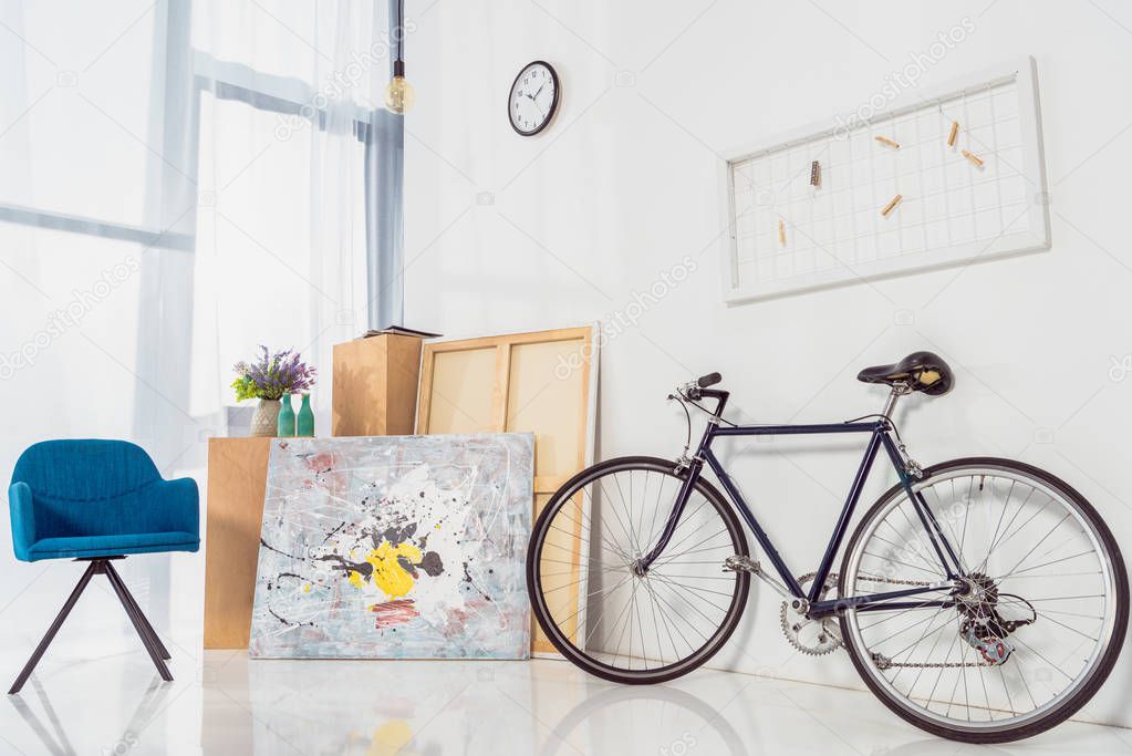 Bicycle and blue chair in modern light room 