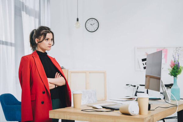 Attractive young girl by working table with computer