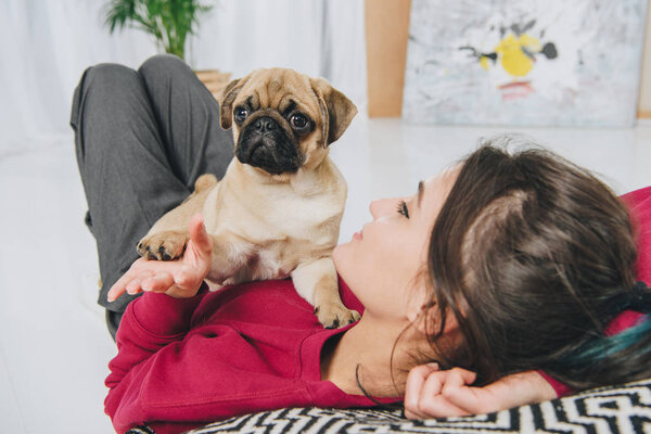 Young Woman Playing Pug Puppy Royalty Free Stock Images