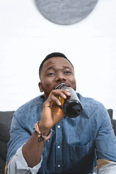 Young African American Man Drinking Beer Bottle — Free Stock Photo