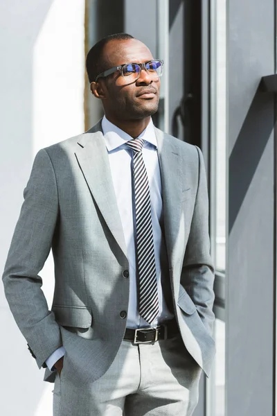 Confident Young African American Businessman Eyeglasses Standing Hands Pockets Looking — Stock Photo, Image