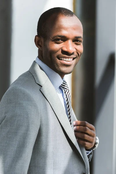 Portrait Handsome Young African American Businessman Adjusting Suit Jacket Smiling — Stock Photo, Image
