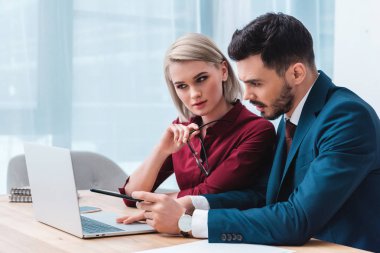 genç işadamı ve birlikte çalışan ve dizüstü bilgisayar kullanma office iş kadını