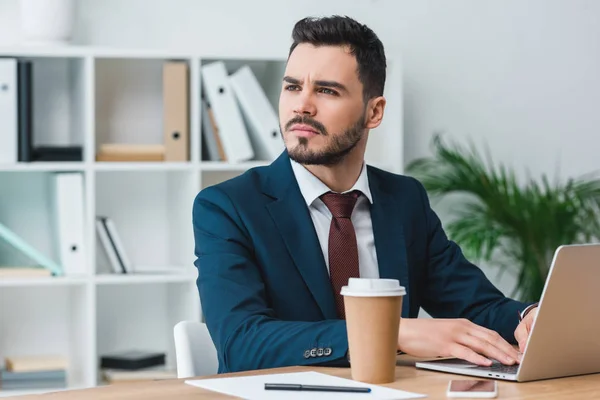 Handsome Young Businessman Using Laptop Looking Away Office — Stock Photo, Image