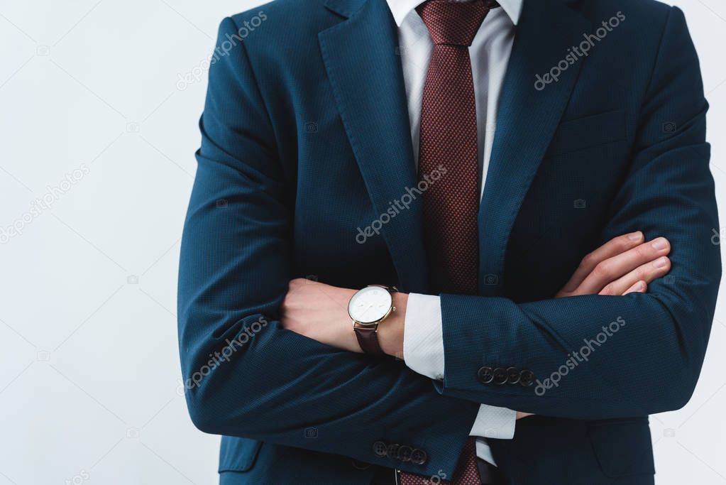 cropped shot of businessman in formal wear standing with crossed arms 