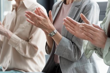 cropped image of businesswomen applauding in office clipart