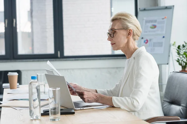 Side View Attractive Senior Businesswoman Eyeglasses Reading Documents Office — Stock Photo, Image