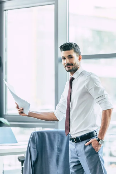 Smiling Businessman Holding Papers While Standing Hand Pocket Looking Camera — Stock Photo, Image