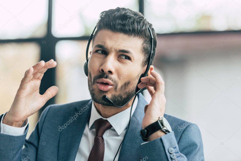 displeased call center operator in headset showing indignation gesture