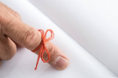 cropped view of senior man with alzheimers disease string human finger reminder near notebook  clipart