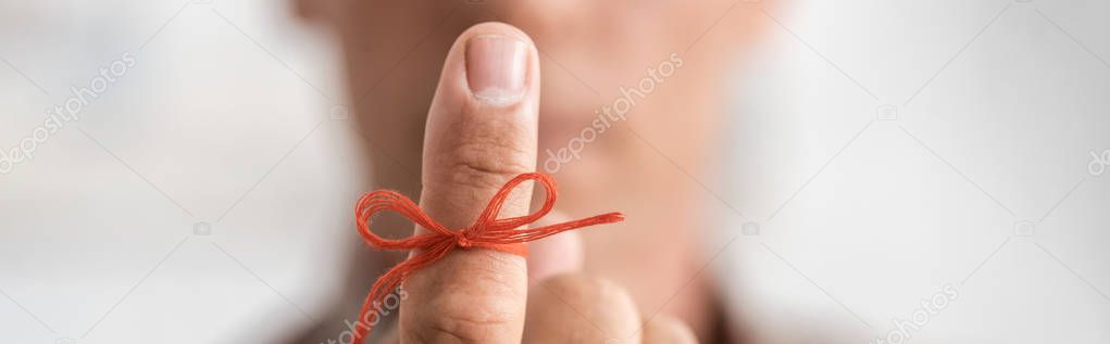 panoramic shot of retired man with alzheimers disease string human finger reminder 