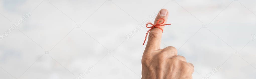 panoramic shot of senior man with alzheimers disease string human finger reminder 