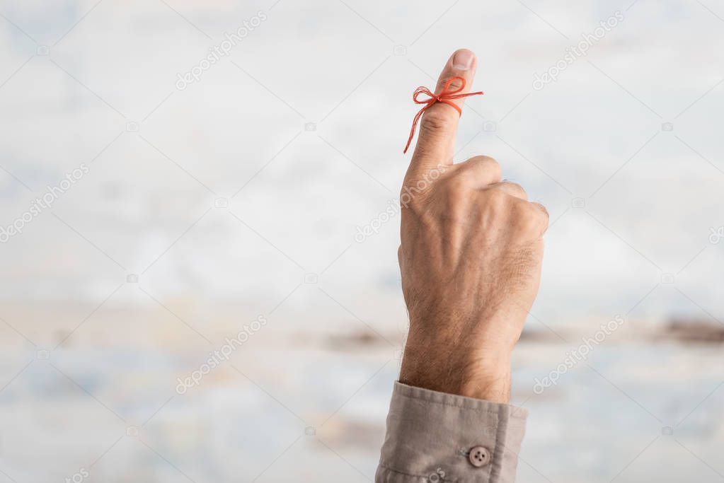 cropped view of senior man with alzheimers disease string human finger reminder 