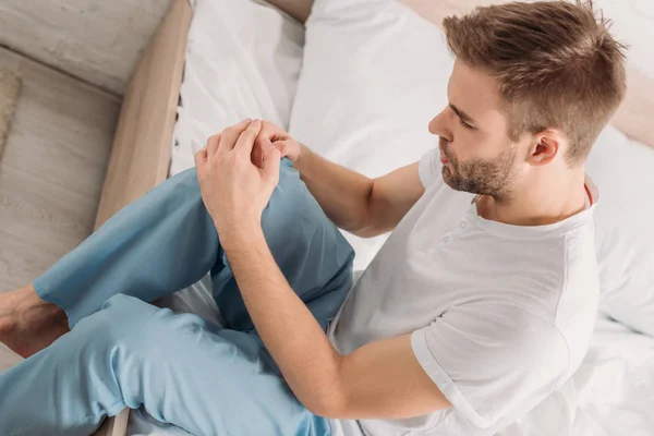 Overhead View Young Man Sitting Bed Suffering Pain Knee — Stock Photo, Image
