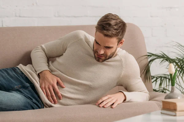 Young Man Lying Sofa Suffering Abdominal Pain — Stock Photo, Image