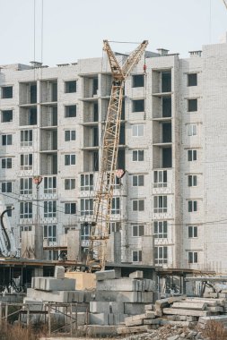 Construction site with crane and concrete blocks clipart