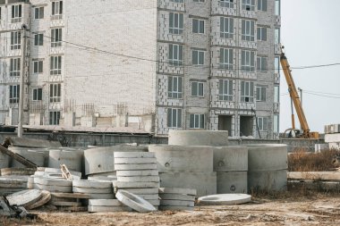 Construction site with building crane and concrete blocks clipart