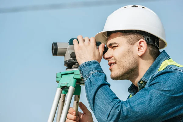 Tampilan Samping Surveyor Dalam Hardhat Mencari Seluruh Tingkat Digital — Stok Foto