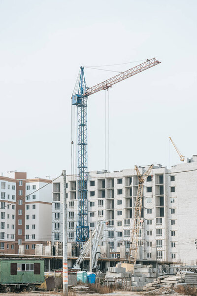 Construction site with cranes and building materials