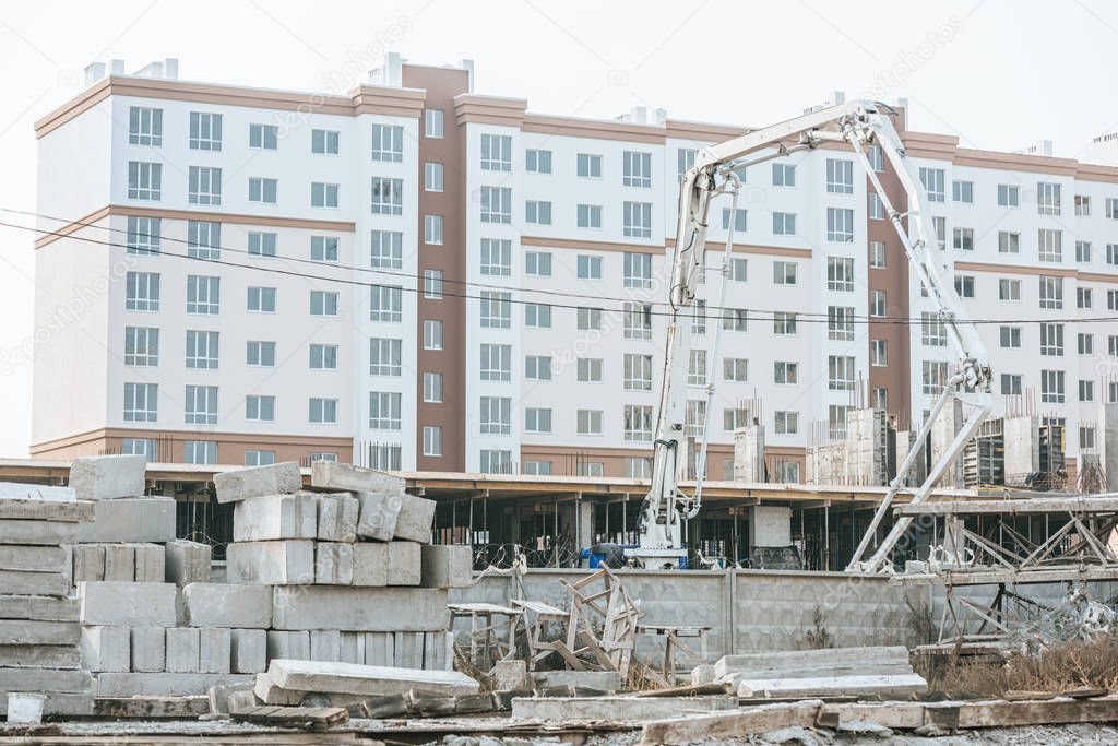 Construction site with crane and concrete blocks