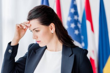 tired and attractive diplomat touching head  clipart