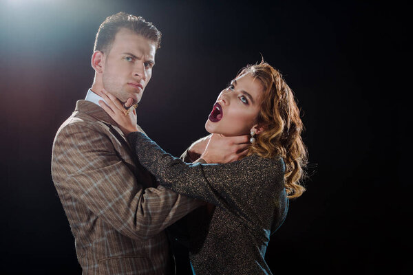 dangerous man choking attractive woman on black 