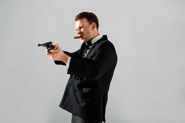 Handsome Gangster Holding Gun While Smoking Isolated Grey — Stock Photo, Image